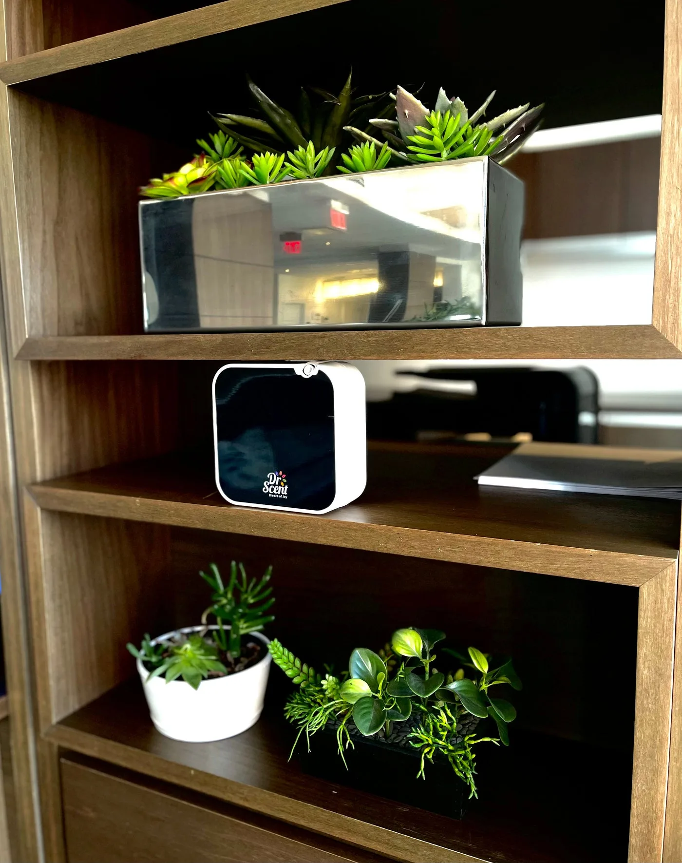 White DR Mini diffuser on a wooden shelf
